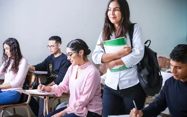 Students working on laptops in a classroom